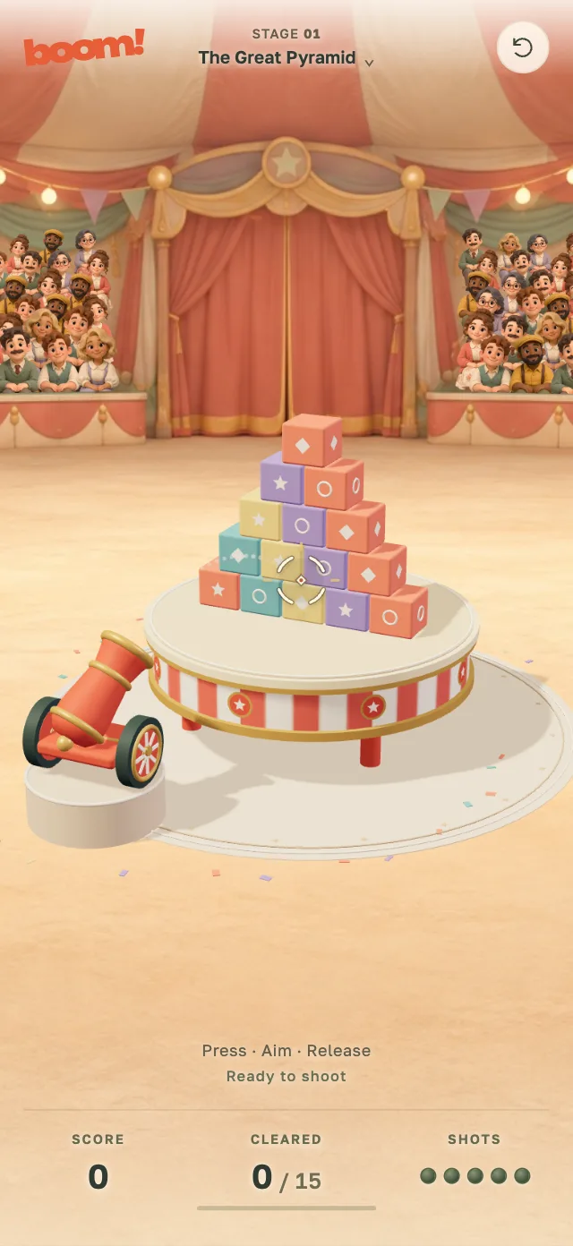 BOOM! on a phone: a circus cannon aimed at a pyramid of colorful props on a striped table, with a cheering crowd behind